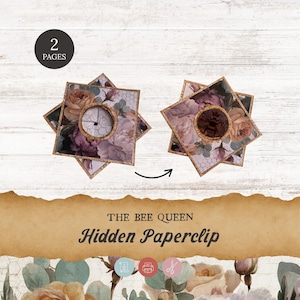 May include: Hidden paperclip with a floral design. The paperclip has a square shape with a circular opening in the centre. The design includes roses and other flowers in shades of pink, purple, and beige. The text "THE BEE QUEEN Hidden Paperclip" is also visible.
