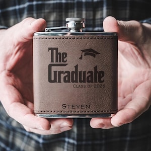 May include: A rustic wooden sign with the text "Welcome to our home" in white lettering. The sign features a distressed finish and a simple, inviting design, perfect for front door decor.