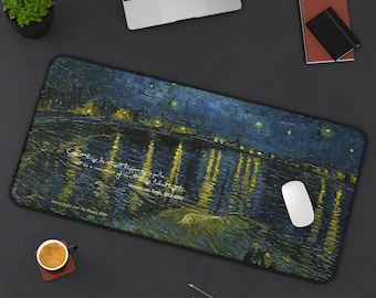 May include: A rectangular desk mat featuring Vincent van Gogh's "Starry Night Over the Rhone" painting. The mat has a dark blue and yellow color scheme, with a quote and the artist's name printed on it. A white computer mouse rests on the mat.