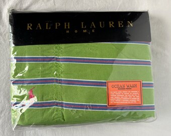 May include: A green and white striped Ralph Lauren Home sheet set with the words "Ocean Wash" and "Washed Fabric" printed on the packaging.