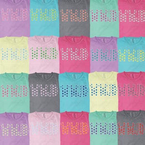 May include: A collection of colorful t-shirts, each displaying the letters "WWJD" in a polka-dot design. The shirts come in various colors, including pink, blue, yellow, and gray, offering a diverse range of options.