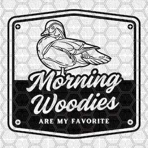 May include: Black and white graphic featuring a wood duck illustration above the words "Morning Woodies ARE MY FAVORITE" in a decorative sign. The sign has a black background and a white border.