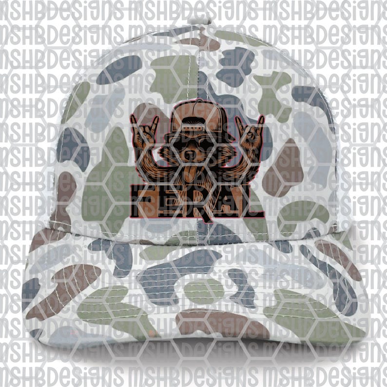May include: A camouflage baseball cap featuring a brown bear graphic with the word "FERAL" in red. The cap has a curved brim and a pattern of white, gray, green, and brown shapes.