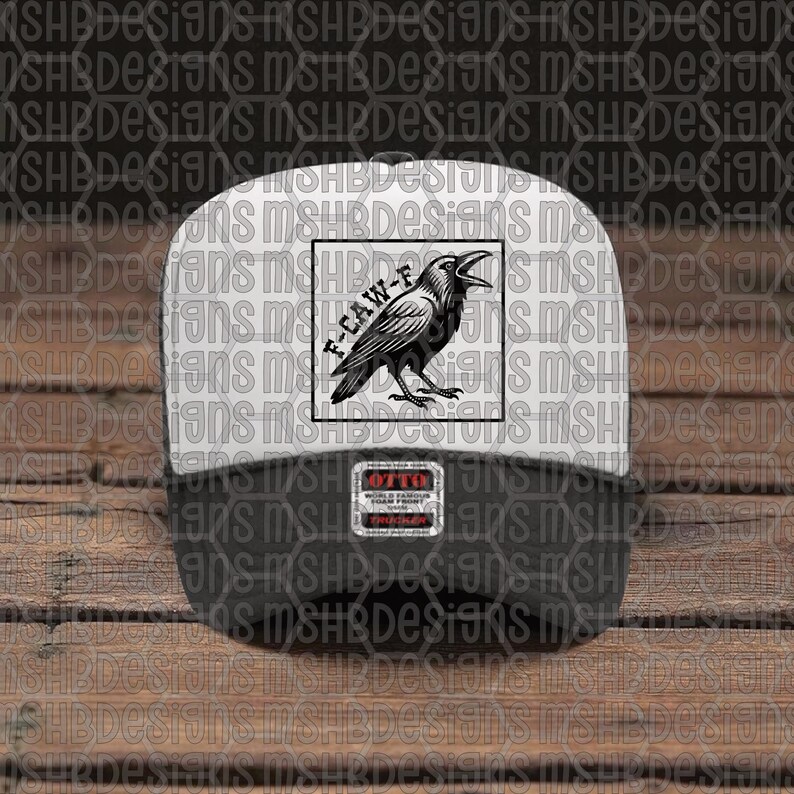 May include: A black and white baseball cap featuring a raven illustration and the text "F-CAW-F" within a square. The cap has a white front and a black peak. The cap has an "OTTO" label.