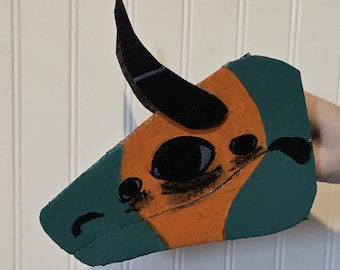 Handmade cardboard dragon puppet named Carno