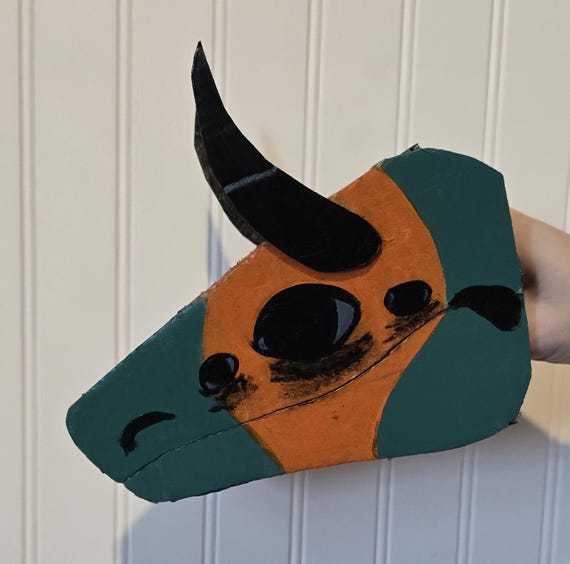 Handmade cardboard dragon puppet named Carno