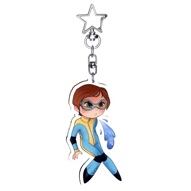 May include: A cartoon keychain featuring a character in a blue and yellow wetsuit with goggles, expelling water. The keychain has a silver star-shaped clasp and chain. The character has brown hair and is in a diving pose.