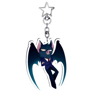 May include: A novelty keychain featuring a cartoon bat character in a blue suit and red tie. The bat has dark blue wings and a stern expression. The keychain has a silver-colored star-shaped clasp.