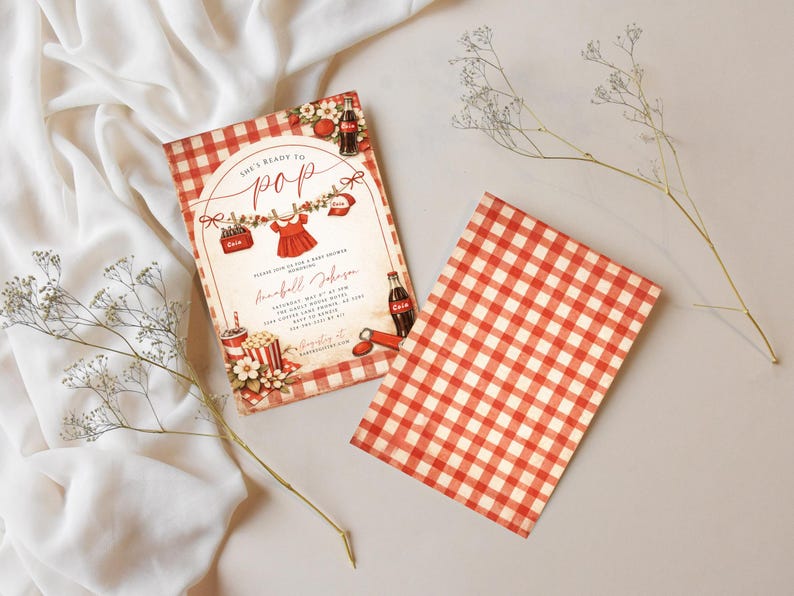 May include: Baby shower invitation with a red and white gingham pattern. The invitation features the text "She's Ready to Pop" and includes illustrations of baby clothes, popcorn, and soda bottles.