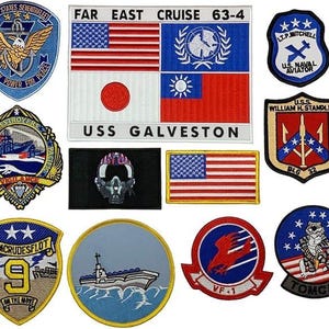 May include: A collection of ten embroidered military patches featuring various designs including the USS Galveston Far East Cruise 63-4, a pilot helmet, a US flag, and several naval ship emblems with text such as United States Seventh Fleet and Tomcat.