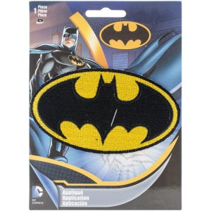 May include: An oval-shaped embroidered patch featuring the iconic black Batman bat symbol on a vibrant yellow background. The patch is displayed on a branded cardboard backing card that shows an illustration of Batman and the DC Comics logo.