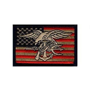 May include: A rectangular embroidered patch featuring a stylized eagle clutching an anchor and a trident, centered over a background of horizontal red and tan stripes with a dark blue field containing small star shapes in the upper left corner.