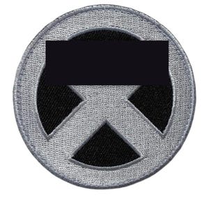 May include: A circular embroidered patch featuring a silver-grey border and a central silver-grey X-shaped design set against a solid black background. The stitching is dense and uniform, creating a textured surface on the round fabric emblem.