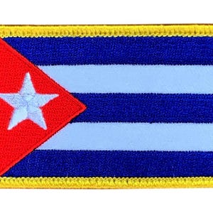 May include: A rectangular embroidered patch featuring the Cuban flag design. It displays three horizontal dark blue stripes alternating with two light blue stripes, a red triangle on the left side, and a white five-pointed star. Yellow border.