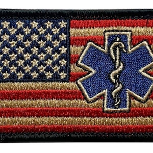 May include: A rectangular embroidered patch featuring the American flag design with red and tan stripes and a blue canton with tan stars. A blue six-pointed Star of Life symbol with a tan border and a central serpent and staff emblem is centered.