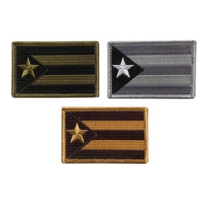 May include: Three rectangular embroidered patches featuring a flag design with horizontal stripes and a triangular section on the left side containing a single star. One patch is black and olive, one is grey and silver, and one is brown and tan.