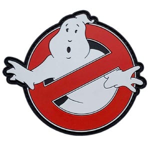 May include: A circular patch featuring a white ghost character with a surprised expression, centered within a red circle crossed by a diagonal red bar. The design is outlined in black, creating a high-contrast graphic emblem with clean lines.