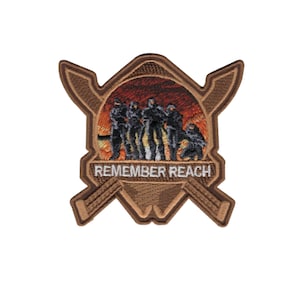 May include: A brown embroidered patch featuring a group of figures silhouetted against a fiery background. The patch is shaped like a shield with crossed swords and the text "REMEMBER REACH".
