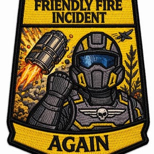 Puede incluir: Parche bordado con un diseño amarillo y negro. El parche presenta un soldado futurista con casco, un misil y las palabras "FRIENDLY FIRE INCIDENT AGAIN."