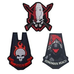 May include: Three embroidered patches with gaming-themed designs. The top patch features a skull with crossed swords and a red and black color scheme. The bottom left patch has a skull with flames and the text "ODST". The bottom right patch says "REMEMBER REACH".