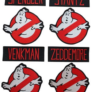 May include: A collection of embroidered patches featuring four rectangular name tags with red text reading SPENGLER, STANTZ, VENKMAN, and ZEDDEMORE on black backgrounds, alongside four circular patches depicting a white ghost inside a red circle.