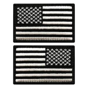 May include: Two rectangular embroidered patches featuring the United States flag in a monochromatic black and white color scheme. The top patch shows the canton on the left, while the bottom patch shows the canton on the right side.