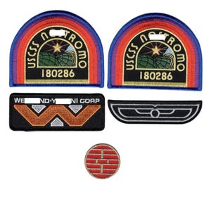 May include: Five embroidered patches including two semi-circular USCSS NOSTROMO 180286 patches with red, orange, and blue borders, a rectangular WEYLAND-YUTANI CORP patch with an orange W, a black and silver wing patch, and a small red circular patch.