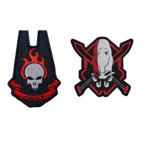 May include: Two embroidered patches. One features a skull with flames and the text "ODST" on a banner. The other patch displays a skull with crossed swords. Both patches have a black background with red and white accents.