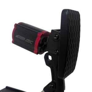 May include: Black and red SIMMAGIC racing pedal with a textured footpad. The pedal features a black base and a red accent on the SIMMAGIC branded component. The footpad has a honeycomb pattern.