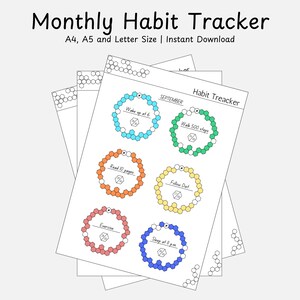 May include: A stack of white habit tracker sheets with colorful circular designs for tracking daily goals. The text "Monthly Habit Tracker" is at the top. The sheets include prompts like "Wake up at 6", "Walk 500 steps", and "Read 10 pages".