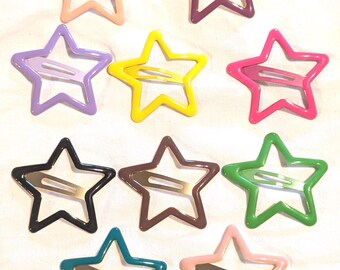 May include: A collection of ten star-shaped hair clips in various colors, including pink, purple, yellow, green, and black. Each clip features a metal clasp and a glossy finish, perfect for adding a playful touch to any hairstyle.