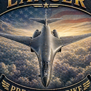 May include: A shield-shaped metal sign featuring a dark gray B-1 Lancer bomber flying over clouds with a faint American flag in the background. The top banner reads LANCER with a star, and the bottom banner reads PRECISION STRIKE in gold lettering.