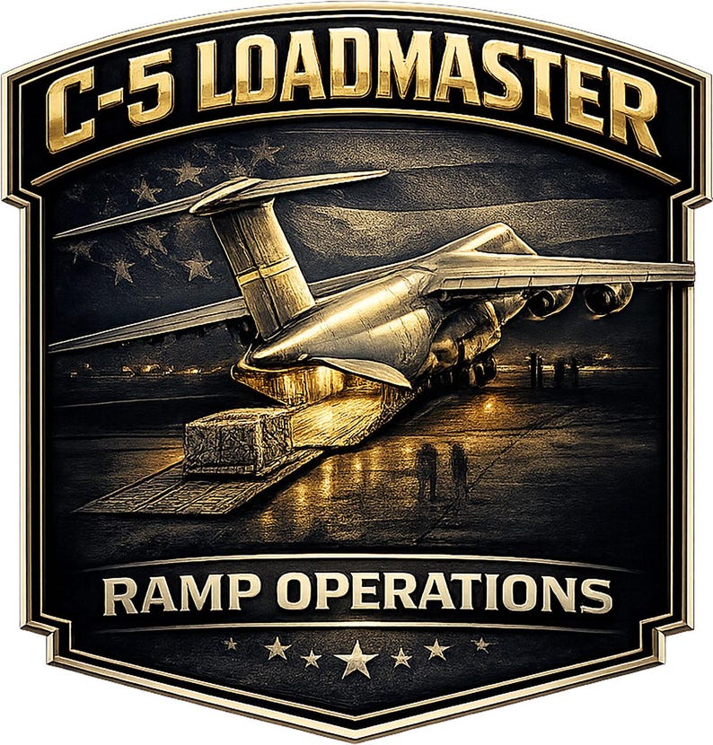 May include: A shield-shaped emblem featuring a C-5 military transport aircraft with its rear ramp lowered for cargo loading. The text C-5 LOADMASTER appears at the top and RAMP OPERATIONS at the bottom in gold lettering against a dark background.