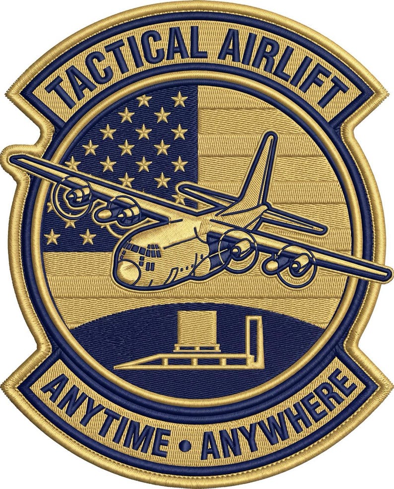 K&ouml;nnte beinhalten: Ein kreisf&ouml;rmiger, bestickter Aufn&auml;her in Gold und Marineblau. Das Design zeigt ein milit&auml;risches Transportflugzeug &uuml;ber einer stilisierten amerikanischen Flagge, mit dem Text TACTICAL AIRLIFT oben und ANYTIME ANYWHERE unten.