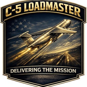 May include: A shield-shaped emblem featuring a metallic C-5 aircraft taking off with bright exhaust flames. The text C-5 LOADMASTER appears at the top and DELIVERING THE MISSION at the bottom. A faint American flag pattern is visible in the background.