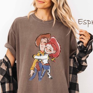 A woman wearing a t-shirt with a cartoon character from the Toy Story franchise.