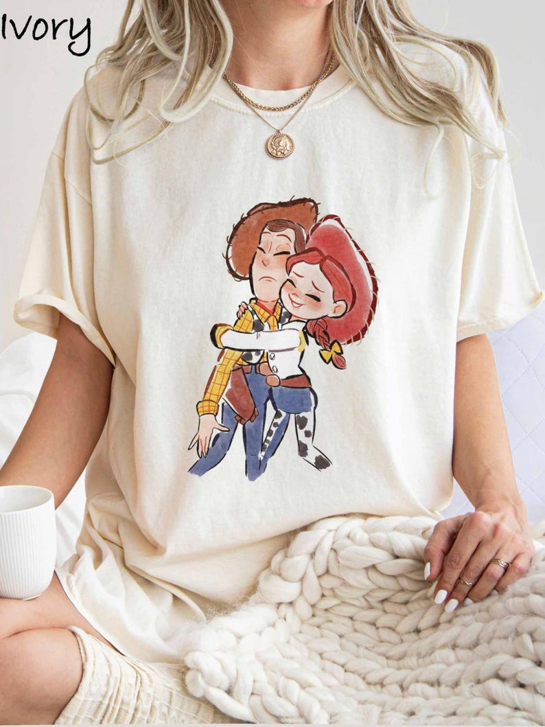 A woman wearing a white t-shirt with a cartoon illustration of two characters from the Toy Story movie.