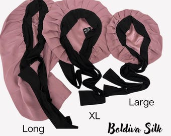 May include: Three silk hair bonnets in varying sizes: Long, XL, and Large. Each bonnet is a dusty rose color with a black interior and long black ties. The text "Boldiva Silk" and "2024 Rated Bestseller" are visible.