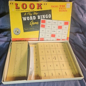 May include: Vintage "Look" Word Bingo game in a yellow box. The box reads "A Play Way Word Bingo Game" and "Teaches 220 Basic Words." Inside are bingo cards and word lists. The game is designed for 2nd grade and up.