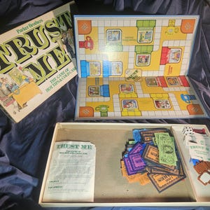 May include: Vintage Parker Brothers "Trust Me" board game. The game includes a game board, cards, play money, dice, and game pieces. The box features the game title in large green and black letters. The game board has a colorful design.
