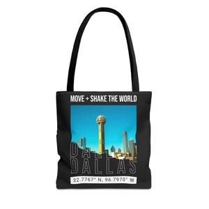May include: Black tote bag featuring a Dallas, Texas skyline with the Reunion Tower. The bag has the text "MOVE + SHAKE THE WORLD" at the top and "DALLAS" with coordinates at the bottom. The bag has black handles.