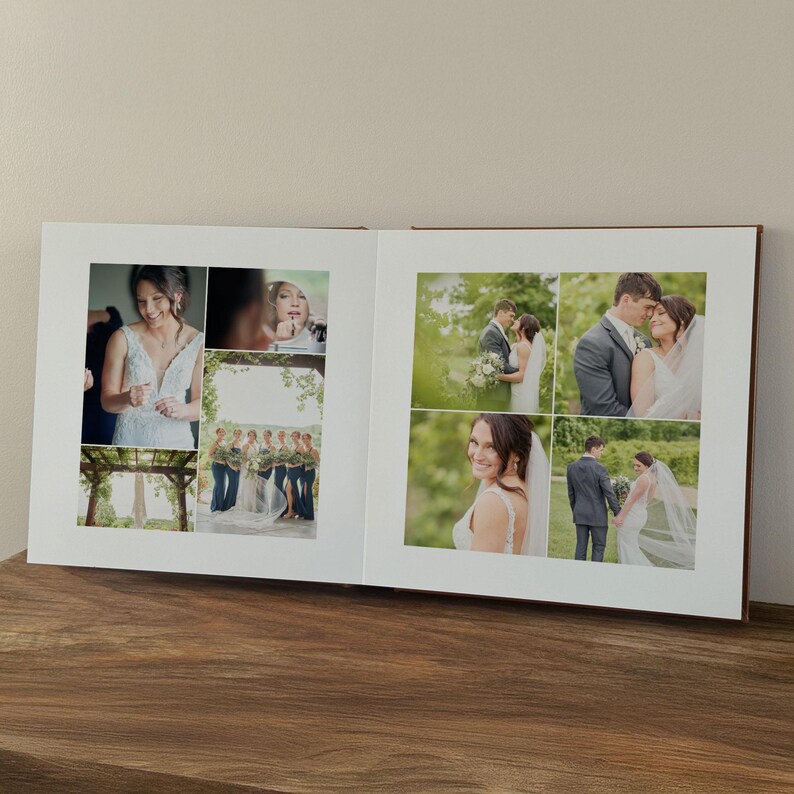 May include: An open photo album featuring a collection of wedding photographs printed on white pages. The images display various scenes including a person in a white gown, a wedding party, and a couple in an outdoor setting with greenery.