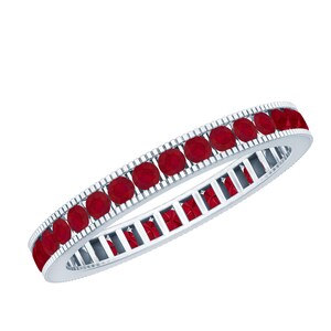 May include: A silver ring set with a continuous line of bright red gemstones. The ring's band has a detailed design, and the gemstones are evenly spaced around the entire circumference, creating a striking and elegant appearance.