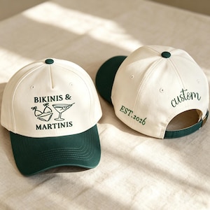 May include: Two baseball caps with cream-coloured crowns and dark green brims. The front cap features the text BIKINIS & MARTINIS with a bikini and martini glass graphic. The back cap displays the text EST. 2026 and the word custom in green.