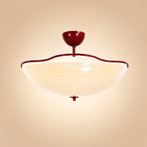 May include: A ceiling light fixture with a red finish and a large, off-white glass bowl. The fixture has a decorative, wavy red trim around the edge of the bowl. The light is suspended from a red canopy.