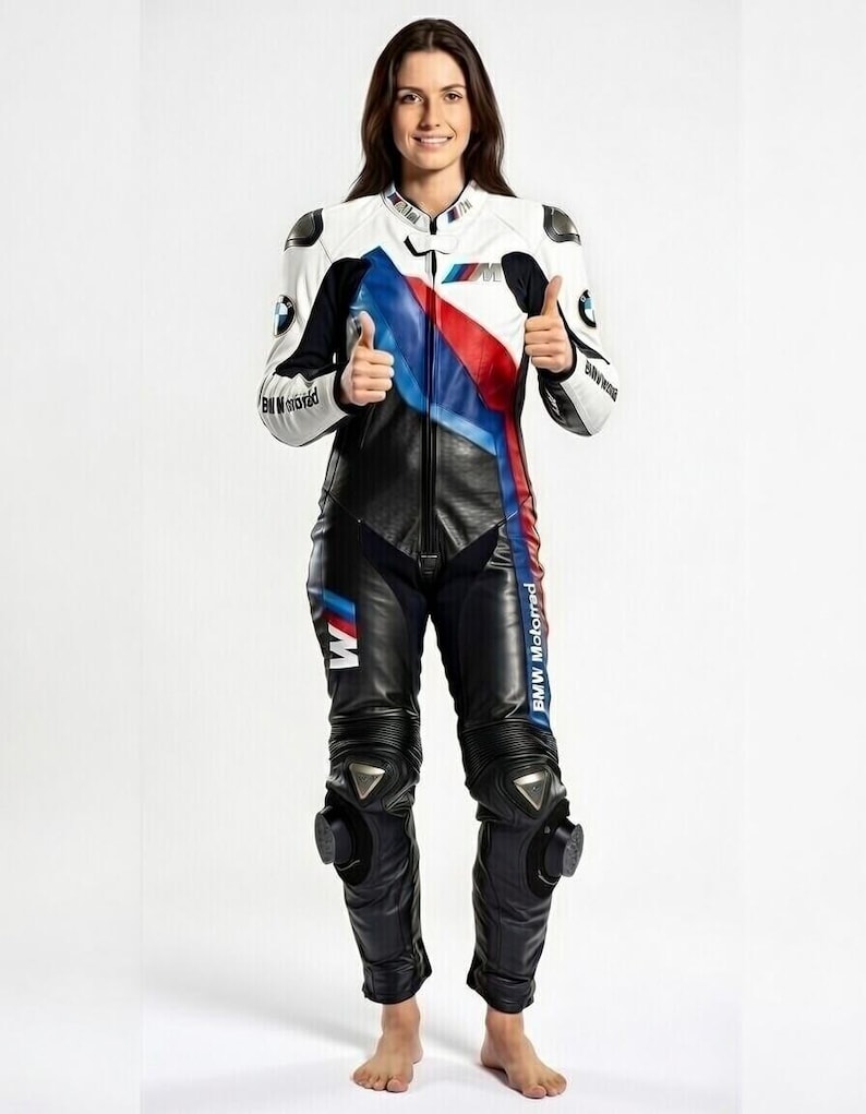 May include: A white, black, and blue BMW Motorrad motorcycle racing suit. The suit features a white upper body with blue and red accents, black leather pants, and protective knee pads. The BMW logo is visible on the chest and sleeves.