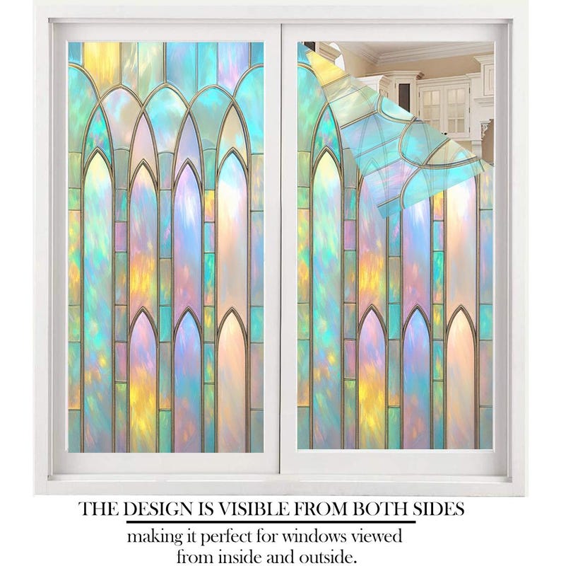 May include: A white window frame with two panes of iridescent window film. The film features a stained-glass design with arched shapes in shades of blue, yellow, and purple. Text at the bottom reads: "THE DESIGN IS VISIBLE FROM BOTH SIDES".