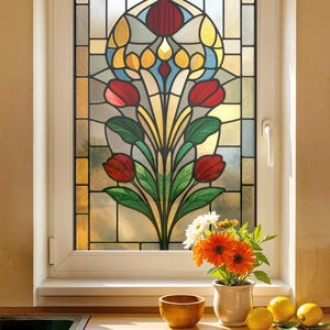 May include: A stained glass window with a floral design featuring red tulips, green leaves, and yellow accents. The window is set in a white frame. A vase of flowers, a wooden bowl, and lemons are on the windowsill.