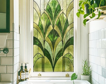 May include: A stained glass window with a green and gold Art Deco design. The window is in a white frame and is in a bathroom setting. The design features a fan-like pattern of leaves and geometric shapes.