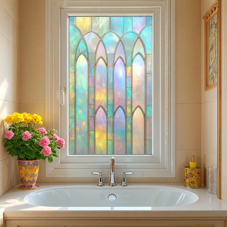 May include: A stained glass window with a colorful, iridescent design is the focal point of this bathroom. The window's pattern features arched shapes and vertical lines, with a palette of blues, greens, yellows, and pinks. A white bathtub and a potted plant are in the foreground.